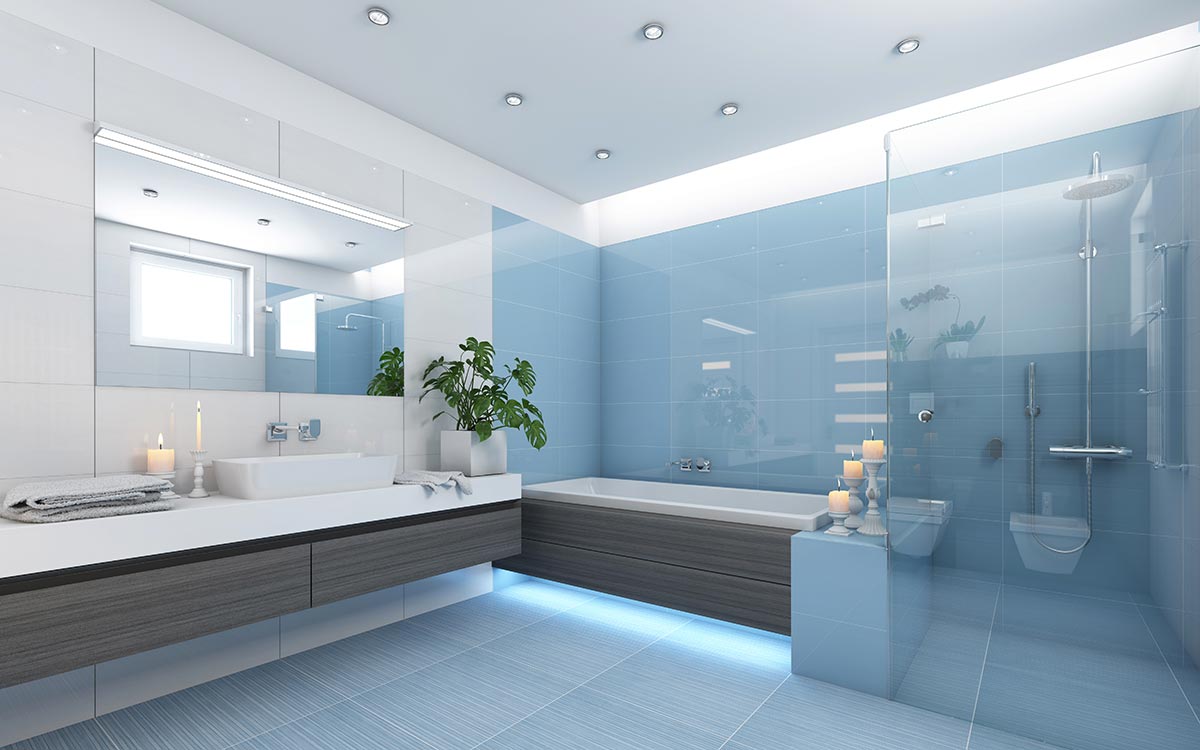 Bagno moderno con parete azzurra e box doccia trasparente.