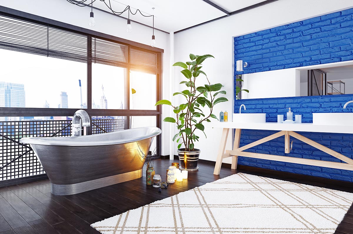 Bagno moderno con vasca nera e bianca e parete in mattoni color blu.